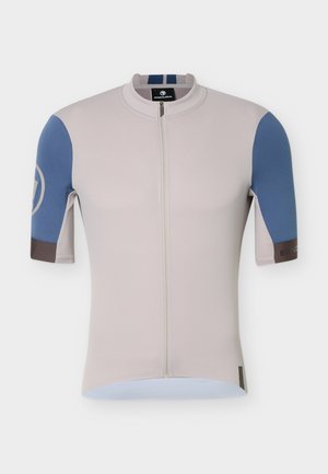 Bež biciklistička majica kratkih rukava s prednjim patent-zatvaračem i plavim panelima na rukavima, s malim logotipom na lijevoj ruci.