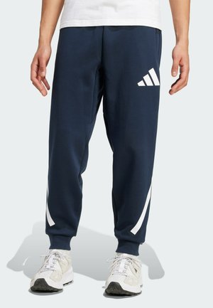 adidas Sportswear Tracksuit bottoms - aurora ink