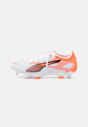 White and orange soccer cleat with a textured mesh upper, black accents, six studs, and lace-up design. Features a sleek, aerodynamic shape.
