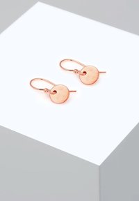 Uhani iz rožnatega zlata s krožnimi diski. Diskom je teksturirana površina in so pritrjeni na preproste zaponke v obliki kljuke.