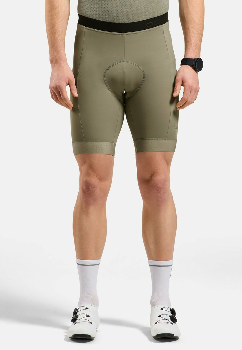 Olijfgroene fietsshorts met een strakke pasvorm, naadloze tailleband en een gevoerd zitgedeelte, met textuur aan de beenopeningen.