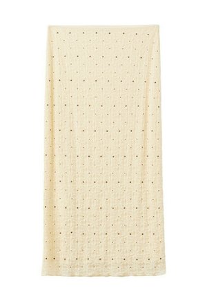 Tissu rectangulaire de couleur crème avec un motif texturé de petits trous régulièrement espacés sur toute la surface.