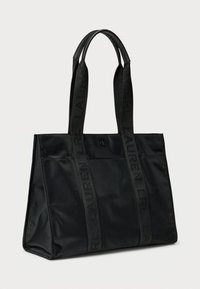 Black tote bag made of nylon with two sturdy, tonal handles featuring engraved branding. Smooth texture and rectangular shape.