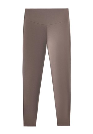 Korkeavyötäröiset, täyspitkät, tiukasti istuvat leggingsit yksivärisenä taupen sävyllä ja V-muotoinen sauma vyötäröllä.