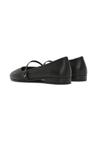 Bailarinas de cuero negro con punta redonda y tacón pequeño, que presentan una correa ajustable y una textura sutil en el material.