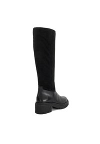 Black knee-high boot with a chunky heel and ridged sole, featuring smooth leather lower and suede-like upper shaft.