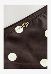 Geselecteerd, chocolate brown cream spot