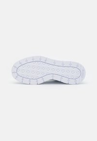 Rubber shoe outsole with a textured pattern featuring star shapes and grooves for traction. Predominantly white with grey accents.