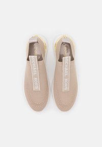 Sneaker slip-on beige con tomaia in rete, fascia bianca con logo e dettagli dorati sul tallone, dotate di suola testurizzata.