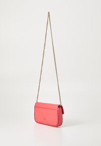 Pink leather crossbody bag with a gold chain strap, rectangular shape, embossed logo detail, and smooth texture.