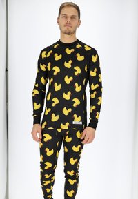 Long-sleeve shirt and leggings in black fabric featuring a repetitive yellow rubber duck pattern with red accents.