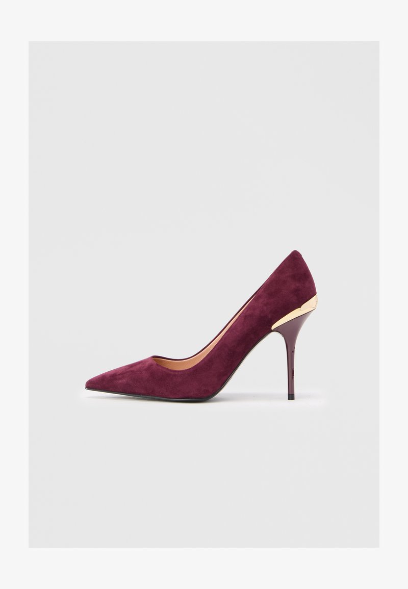 Women's burgundy suede high-heeled pump with a pointed toe and gold accent near the heel, set against a plain light background.