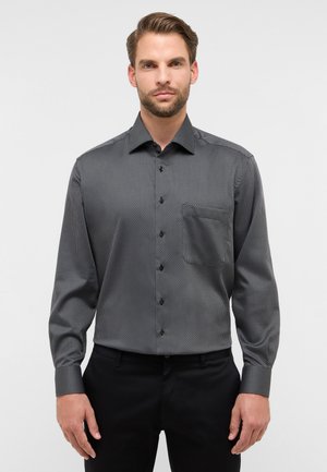 Zwart-wit gestreepte lange mouwen shirt met een button-down kraag, een borstzak en zwarte knopen. Gladde stof met een gestructureerde pasvorm.