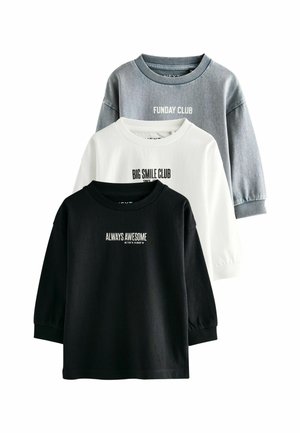 Trois sweat-shirts en coton de couleur noire, blanche et grise. Chacun possède un col rond et un texte imprimé : "TOUJOURS GÉNIAL," "CLUB DES GRANDS SMILES," "CLUB DES JOURS DE FÊTE."