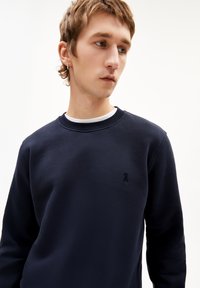 Navyblauwe sweatshirt van een katoenmix, met een ronde hals, ribgebreide manchetten en een klein geborduurd lintlogo op de borst.