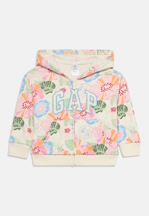 Sudadera con cremallera para niños con estampado floral pastel, bolsillo delantero, puños crema y logo "GAP" en letras azules en el pecho.