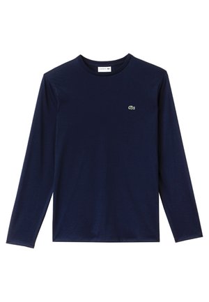 T-shirt à manches longues marine en coton doux. Doté d'un col rond, d'une coupe droite et d'un petit logo vert sur la poitrine.