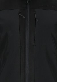 Black zip-up jacket with a smooth texture, featuring a central zipper and two drawstring adjustments near the collar.
