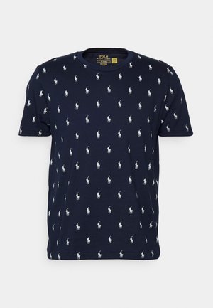 Navy blue cotton t-shirt with a crew neck and all-over white polo player pattern. Short sleeves with a straight hem.