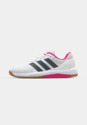 White athletic shoes with gray stripes, a mesh upper, pink accents on the collar and outsole, and a rubber gum sole. Ergonomic design.