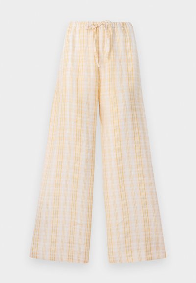 Ευρύχωρα παντελόνια φτιαγμένα από ελαφρύ ύφασμα σε παλ κίτρινο και λευκό καρό μοτίβο. Διαθέτουν ελαστική μέση με κορδόνι προσαρμογής.