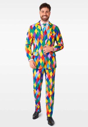 Costume coloré avec de grands motifs en losanges dans des teintes de rouge, jaune, vert et violet. Design ajusté avec un pantalon assorti et une cravate bleu clair.