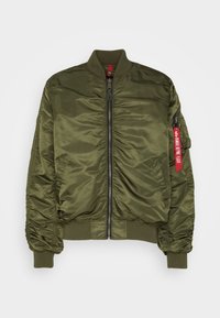 Olive green bomber jacket made of glossy nylon, featuring a front zipper, ribbed cuffs, and a red tag detail on the sleeve.