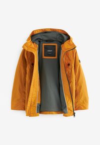 Veste légère orange avec capuche, dotée d'une doublure intérieure grise, fermeture éclair et deux poches extérieures. Présentée ouverte.