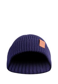 Knit beanie in deep navy blue, featuring a textured ribbed design and a brown leather patch on the front with embossed logo detail.