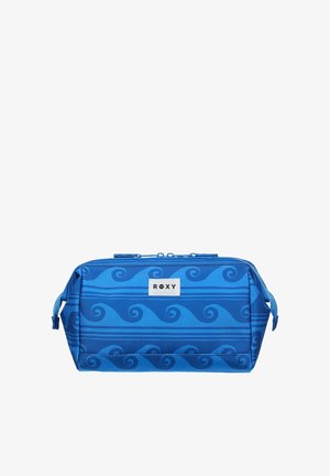 Blauwe rechthoekige toilettas met golfpatronen, zijhandvatten, ritssluiting en witte "ROXY" logopatch aan de voorkant.