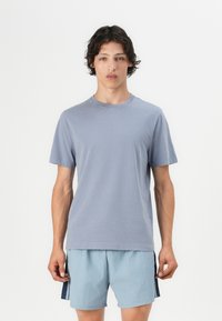 Lyseblå crew-neck t-shirt lavet af blødt bomuld, med korte ærmer og en afslappet pasform, parret med lyseblå shorts.