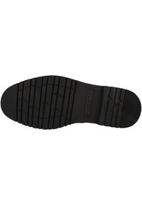 Talpa de pantof din cauciuc negru cu un model texturat pentru aderență, având linii orizontale și verticale pentru tracțiune, marcate cu numele brandului.
