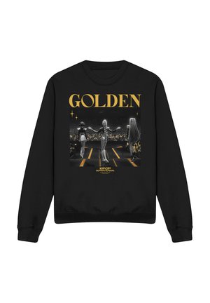 Black sweatshirt with golden text "GOLDEN" above three women walking on stage toward an audience holding glowing lights.