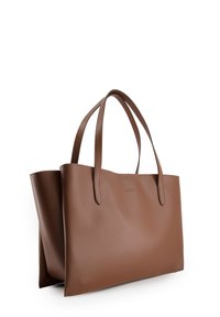 Brown leather tote bag with two long handles, sleek rectangular shape, smooth texture, and subtle branding on the side.