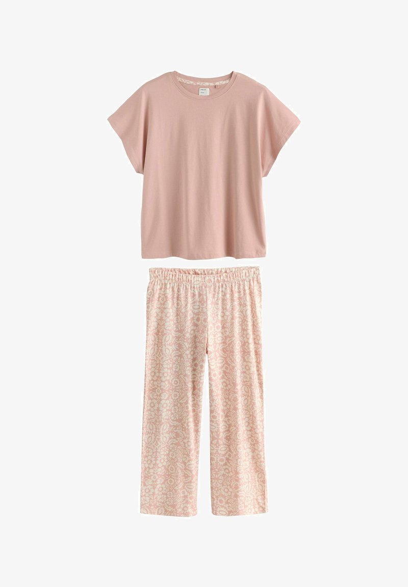 Haut à manches courtes rose pâle à coupe large associé à un pantalon à taille élastique à motif floral rose clair pour une tenue décontractée.