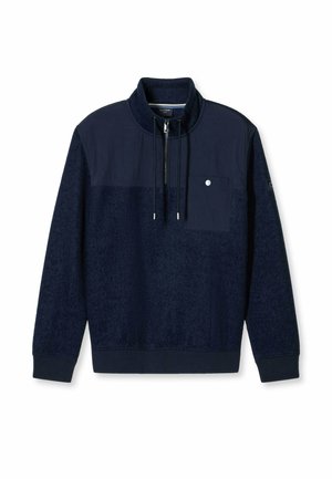 Navy pullover sweatshirt with a high collar, front pocket, and drawstrings. Features a textured fabric and smooth sections.