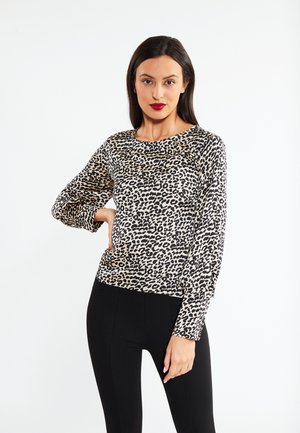 Top a maniche lunghe con stampa leopardata in beige e nero, con scollatura rotonda e vestibilità comoda. Abbinato a leggings neri.