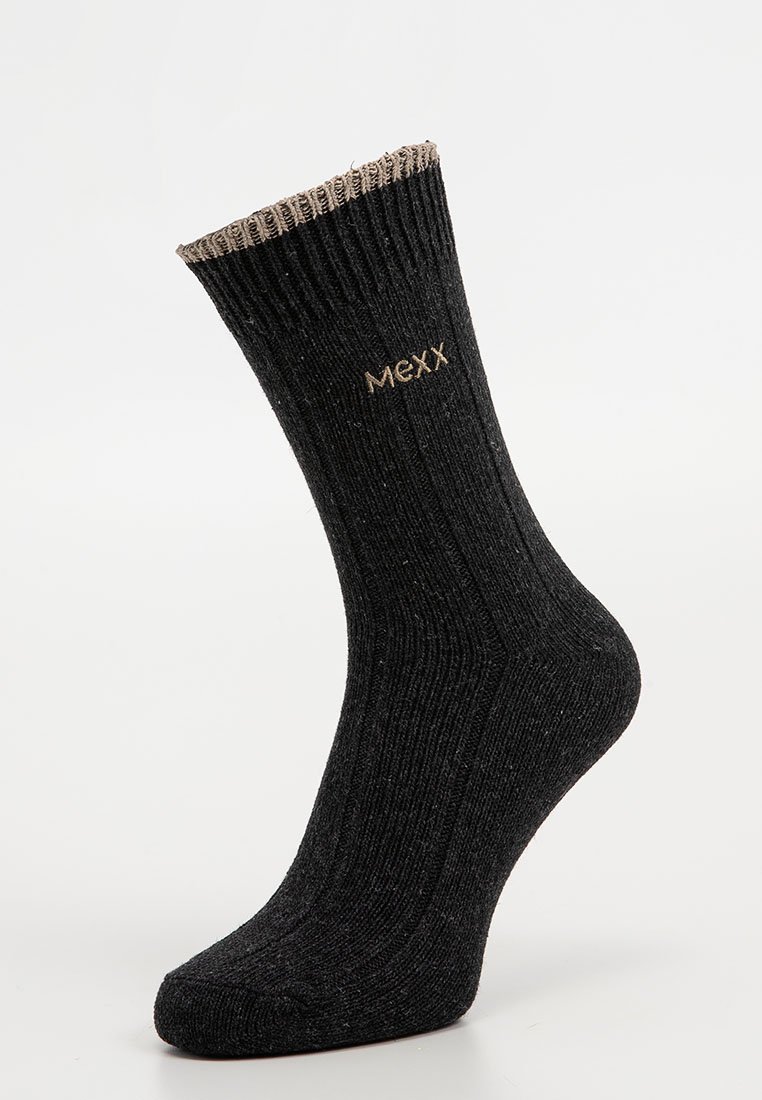 Schwarze gerippte Socke mit braunem oberen Rand und dem gestickten "Mexx"-Logo nahe dem Knöchel, auf einem Mannequinfuß vor weißem Hintergrund präsentiert.