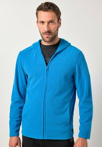 Niebieska polarowa bluza z kapturem na zamek, z długimi rękawami i gładką fakturą. Z przodu zamek błyskawiczny oraz czarny akcent przy krawędzi. Casualowy design.