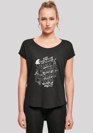 Black, loose-fitting t-shirt with rolled sleeves featuring white text design that reads, “There are no strange creatures only blinkered people.”