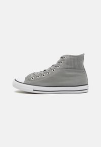 Gray high-top sneakers with textured fabric, white rubber toe cap, and black stripe at the sole. Features classic lace-up design.