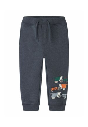Pantalon gris foncé pour tout-petit avec taille élastique et cordon, avec des illustrations colorées de tracteur et de remorque sur la partie inférieure de la jambe droite.