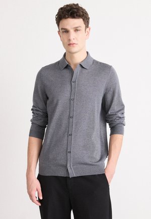 Gray button-up cardigan with a collar, knitted fabric, long sleeves, and ribbed cuffs. Displayed on a model against a neutral background.