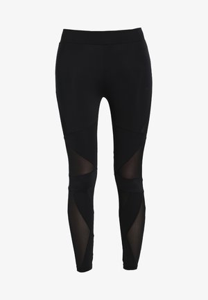 Leggings neri realizzati in tessuto elasticizzato, con pannelli trasparenti e ritagli angolari lungo i lati per un tocco di dettaglio e design in più.