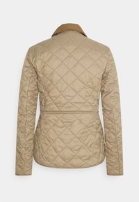 Μπεζ επενδυμένο μπουφάν με κοτλέ γιακά, δομημένη μέση, μακριά μανίκια και διαμαντένιο μοτίβο στο ύφασμα.