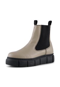 Botín de cuero beige hasta el tobillo con paneles laterales elásticos negros, una suela gruesa negra y un acabado texturizado. Cuenta con tiradores para facilitar su uso.