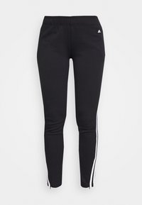 Pantalones atléticos negros hechos de material suave, con un ajuste slim, franjas laterales blancas y una cinturilla para mayor comodidad.