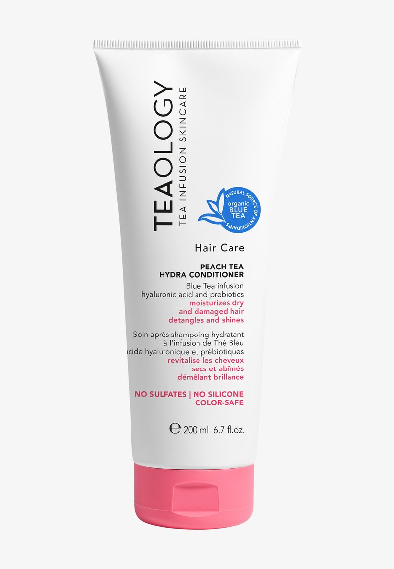 Après-shampooing hydratant à la pêche Teaology dans un tube blanc, avec des accents roses, une étiquette bleue et des détails textuels sur les avantages. Format de 200 ml.