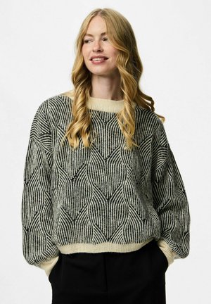 Suéter de punto con un patrón de ondas en negro y crema, con cuello redondo y puños acanalados. Diseño de ajuste holgado con tejido texturizado.