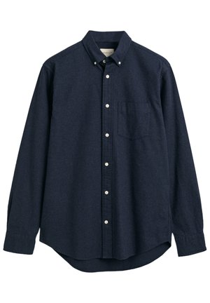 Camicia blu navy, con bottoni e realizzata in tessuto texturizzato. Caratterizzata da un colletto, maniche lunghe e una singola tasca sul petto. Design con orlo dritto.